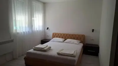 a bedroom with a bed with two towels on it at Comfort in Budva