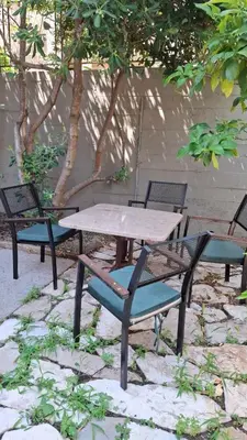 a wooden table and chairs and a table and chairs at Comfort in Budva