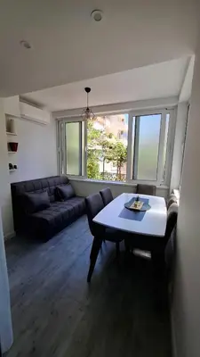 a living room with a table and a couch at Comfort in Budva