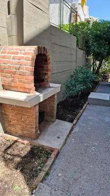 a brick oven sitting on the side of a house at Comfort in Budva
