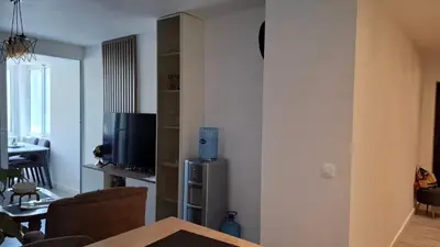 a living room with a television and a dining room at Comfort in Budva