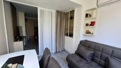 a living room with a couch and a table at Comfort in Budva