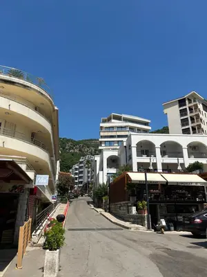 an empty street in a city with tall buildings at Sunny stay Budva in Rafailovici