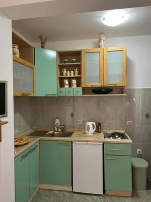 a kitchen with blue and white cabinets and a sink at Sunny stay Budva in Rafailovici