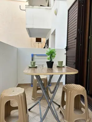 a table and two stools in a room at Sunny stay Budva in Rafailovici
