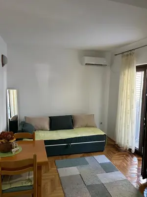 a living room with a couch and a table at Sunny stay Budva in Rafailovici