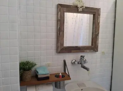 a bathroom with a sink and a mirror at Budva Old City Central Studio Private in Budva