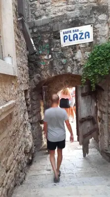 a man walking through a tunnel in a stone building at Budva Old City Central Studio Private in Budva