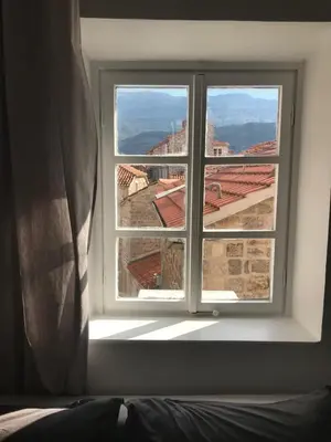 a window in a room with a view of a city at Budva Old City Central Studio Private in Budva