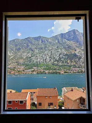 a view from a window of a city and a mountain at Spacious apartment Kotor in Kotor