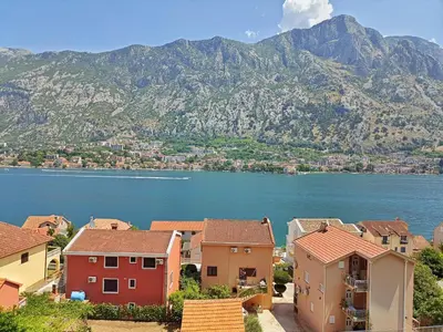 a view of a town with a lake and mountains at Spacious apartment Kotor in Kotor