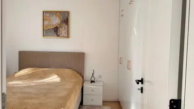 a bedroom with a bed and a picture on the wall at Pearl Wave-Apartment in Ulcinj