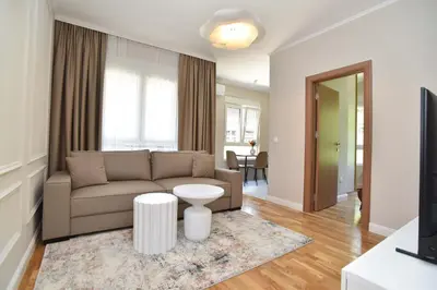 a living room with a couch and a table at Comfy one-bdr apartment Sara in Budva