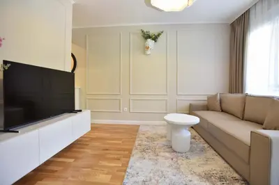 a living room with a couch and a flat screen tv at Comfy one-bdr apartment Sara in Budva