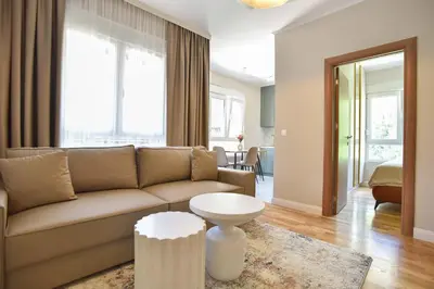 a living room with a couch and a table at Comfy one-bdr apartment Sara in Budva