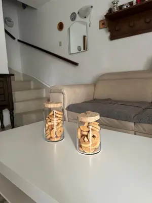 two jars of donuts sitting on a table in a living room at Iskra house - Perazica Do in Perazića Do