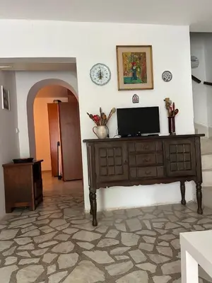 a living room with a television on a wooden dresser at Iskra house - Perazica Do in Perazića Do