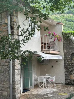 a table and chairs in front of a building at Iskra house - Perazica Do in Perazića Do