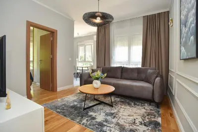 a living room with a couch and a table at Comfy one-bdr apartment Staša in Budva