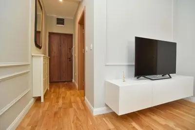 a living room with a flat screen tv on a white cabinet at Comfy one-bdr apartment Staša in Budva