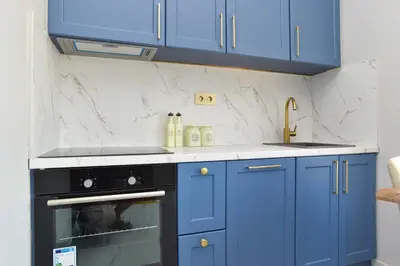 a kitchen with blue cabinets and a sink at Comfy one-bdr apartment Staša in Budva