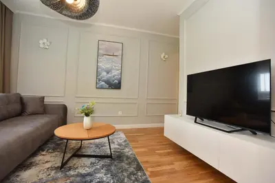 a living room with a large flat screen tv at Comfy one-bdr apartment Staša in Budva