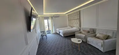 a living room with a couch and a bed at KASIJA Apartman in Podgorica