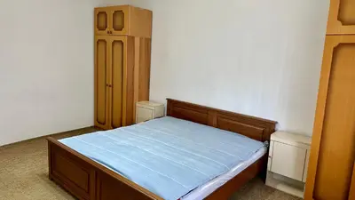 a small bedroom with a bed and a cabinet at Adria spa Rafailovici in Becici