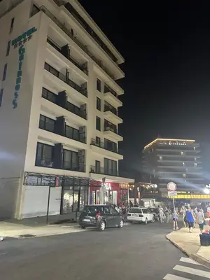 a parking lot in front of a building at night at AB LUX Apartmani 401 in Sutomore