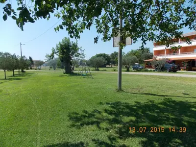 a park with a basketball hoop in the grass at Delfini Holiday Homes in Ulcinj