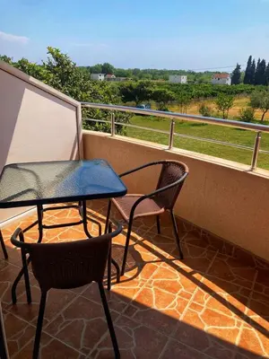 a balcony with a table and two chairs and a view at Delfini Holiday Homes in Ulcinj