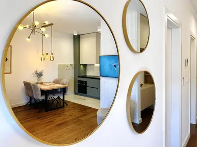 a mirror on a wall in a kitchen with a table at Harmony Sun 39 in Bar