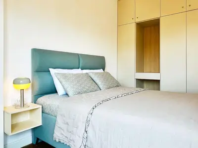 a bedroom with a bed with a blue head board at Harmony Sun 39 in Bar
