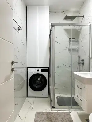 a white bathroom with a washing machine in a shower at Harmony Sun 39 in Bar