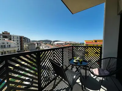a balcony with chairs and a table with a view at Harmony Sun 39 in Bar