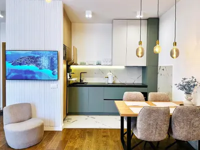a kitchen with a table and some chairs and a kitchen at Harmony Sun 39 in Bar