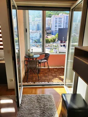 a balcony with a table and a view of a city at MiraBlu - New Modern Apartment - FREE parking in Budva
