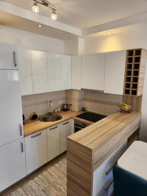 a kitchen with white cabinets and a sink at MiraBlu - New Modern Apartment - FREE parking in Budva