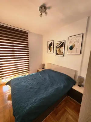a bedroom with a bed and a window at MiraBlu - New Modern Apartment - FREE parking in Budva