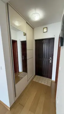 a hallway with a large mirror and a door at VISTA Kalamper MONTENEGRO in Dobra Voda