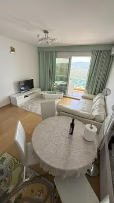 a living room with a couch and a table at VISTA Kalamper MONTENEGRO in Dobra Voda