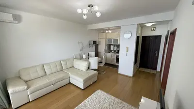 a living room with a white couch and a kitchen at VISTA Kalamper MONTENEGRO in Dobra Voda