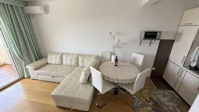 a living room with a white couch and a table at VISTA Kalamper MONTENEGRO in Dobra Voda