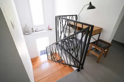 a stairway with a desk and a lamp and a chair at Vila Mirko in Kotor