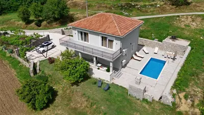 an overhead view of a house with a swimming pool at Vila Mirko in Kotor