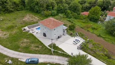 an aerial view of a house with a car parked in the driveway at Vila Mirko in Kotor