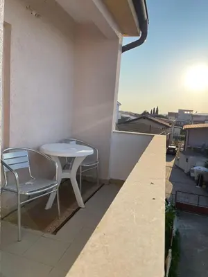 a table and chairs on the balcony of a building at Apartmani Arieta in Donji Štoj