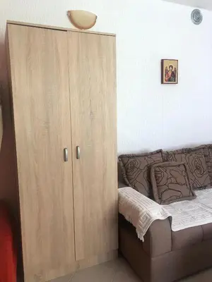 a large wooden cabinet next to a couch at Apartmani Marina Sutomore in Sutomore