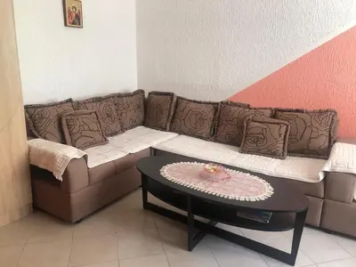a living room with a couch and a table at Apartmani Marina Sutomore in Sutomore