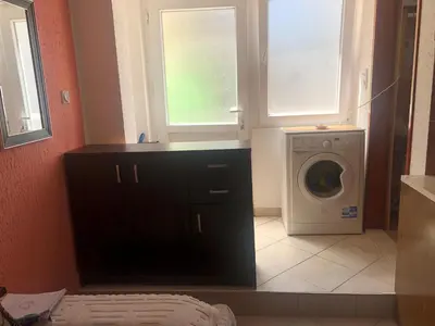 a laundry room with a washing machine and a washer at Apartmani Marina Sutomore in Sutomore